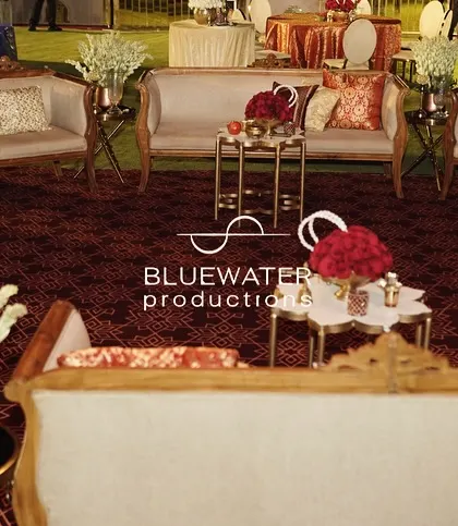 A lounge area at the red-and-gold wedding, with classic furniture and cushions in shades of red and orange.
