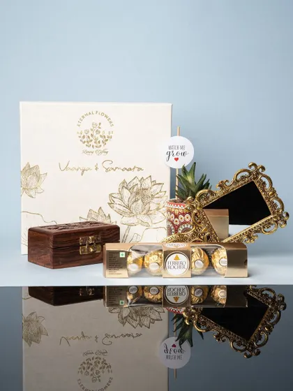 An elegant return gift hamper for the naming ceremony of twins, Vaanya & Samaara. The custom box features their names and a beautiful lotus design.