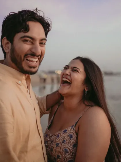 A close-up filled with infectious laughter. This candid shot captures the pure joy and fun of a day spent by the sea, reflecting a genuine and happy connection.