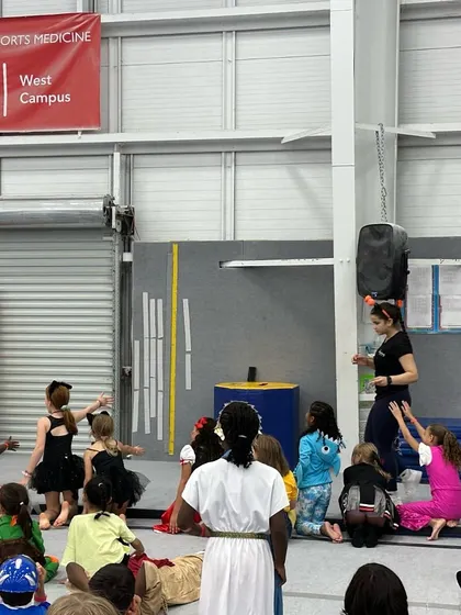 Our coaches leading a group of costumed kids in a game during our Halloween event. We ensure all activities are structured, safe, and incredibly fun for everyone involved.