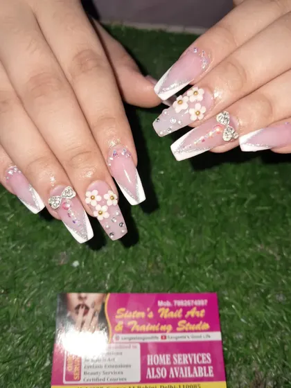 A beautiful and elegant set for a special occasion. These long coffin nails feature a French ombre base with delicate 3D flowers and sparkling stone bows.