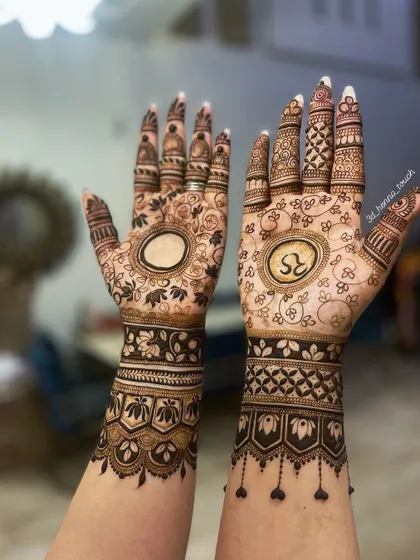 A personalized bridal design featuring the initials 'RS' and elephant motifs. The empty circle on the other hand is often used to write the groom's name.