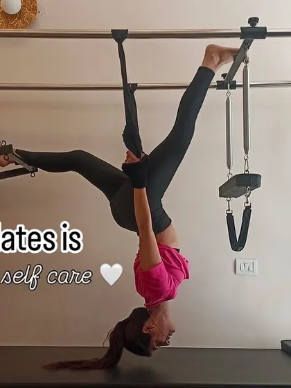 An inverted stretch on the Cadillac, showing the playful and therapeutic side of Pilates. It's about finding new ways to move and care for your body.