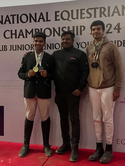 Two of our young riders with their coach, showcasing a haul of medals from the Junior National Equestrian Championship. Their success spans dressage, eventing, and show jumping.