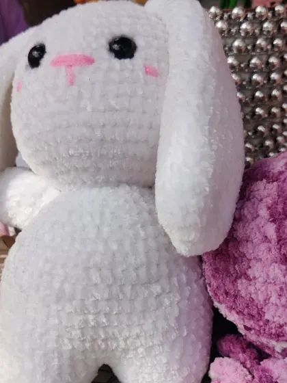 A close-up of the bunny's sweet, hand-stitched face.
