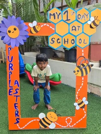 Posing in our 'First Day at School' photo frame. These pictures become treasured memories for parents.