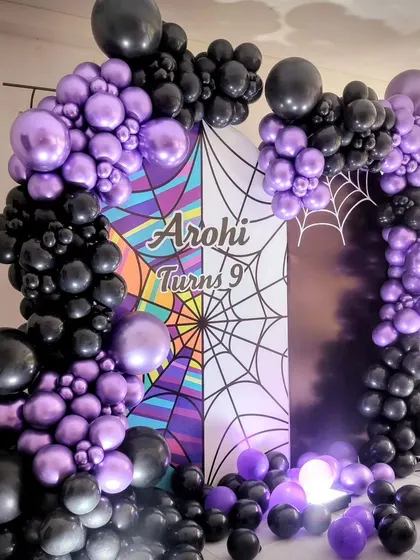 Another view of the purple and black balloon arch for the spooky theme.