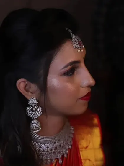 A side profile showcasing the elegant updo and the contouring that defines her features beautifully.