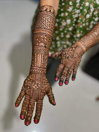 A single-hand focus of the "MS" bridal mehendi.