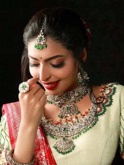 A beautiful close-up of a model in a bridal look. Her gentle smile and the way she touches her nose ring create a soft and feminine portrait, highlighting her intricate silver jewelry.