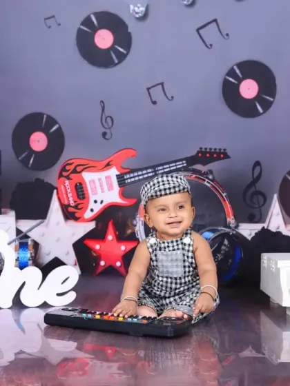 Another angle of the music-themed session, showing the baby happily playing with a toy keyboard. The entire setup is designed to be engaging and fun for the child.