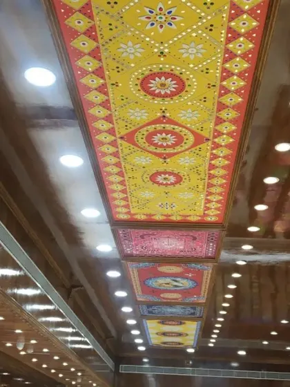 A close-up of the installed ceiling panels, highlighting the intricate geometric and floral patterns of the Lippan art.