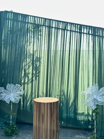 A simple yet elegant cake-cutting station for a baby shower. The sage green backdrop and minimalist wooden pedestal perfectly complemented the rustic and natural theme of the event.
