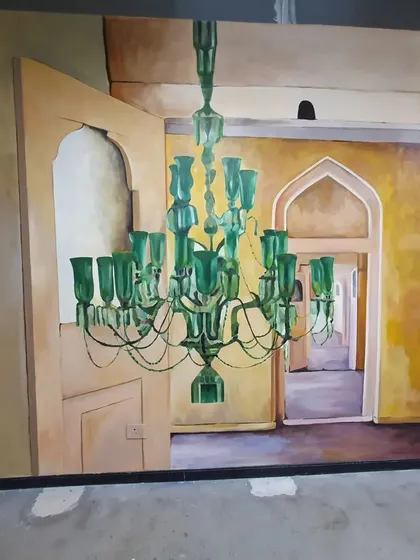 This is a duplicate image focusing on the hand-painted green chandelier, a key feature of the Microsoft Hyderabad mural.