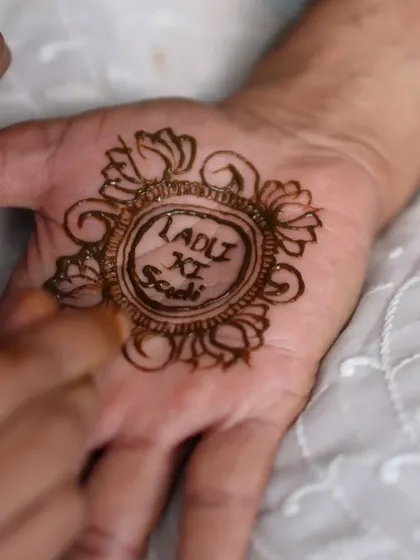 "Ladki ki Shaadi" captured in a beautiful henna design. These small, customized details for family members make everyone feel included in the celebration.