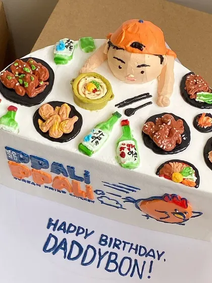 This cake is a tribute to Korean fried chicken, complete with tiny bottles of soju and side dishes, all handcrafted from fondant.