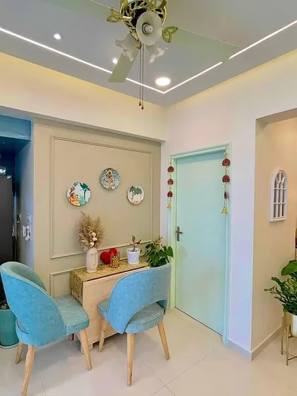 This cozy dining nook is perfect for family meals. I used pastel aqua chairs, decorative wall plates, and fresh plants to create a space that feels both elegant and welcoming.