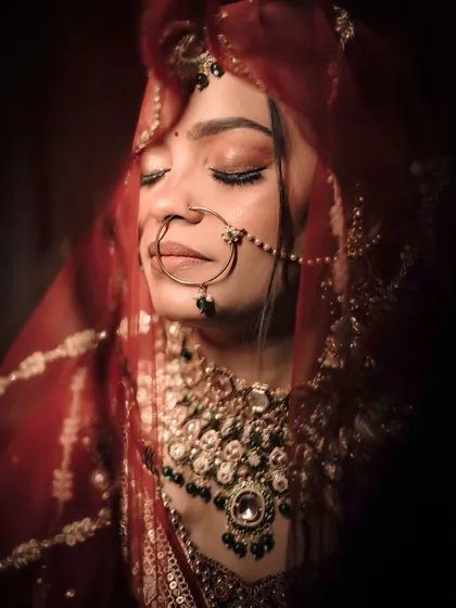 A close-up bridal portrait focusing on the serene expression and intricate details of the jewelry. We use moody lighting to create a timeless and elegant feel.
