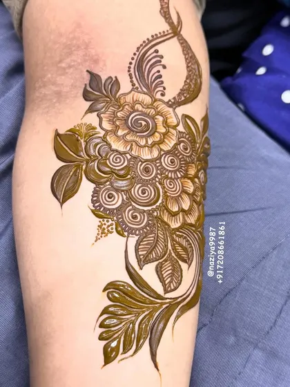 A gorgeous floral bunch design for the arm. The mix of shaded flowers and delicate leaves creates a beautiful composition.