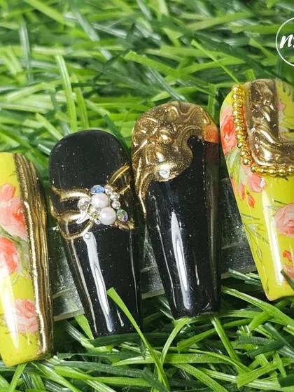 An example of embossed chrome nails. This set combines hand-painted florals with bold, 3D chrome accents for a look that is both artistic and luxurious.