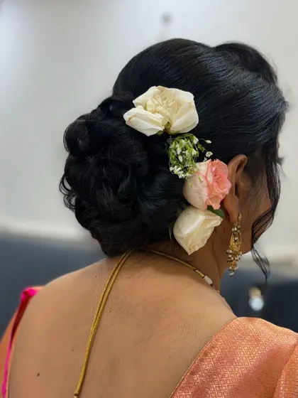 A close-up of the intricate bun and the beautiful fresh flowers.