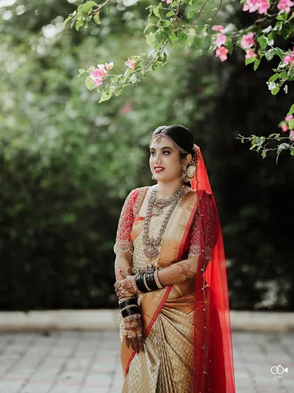 A beautiful outdoor portrait of the bride, framed by the soft pink flowers of a bougainvillea tree.