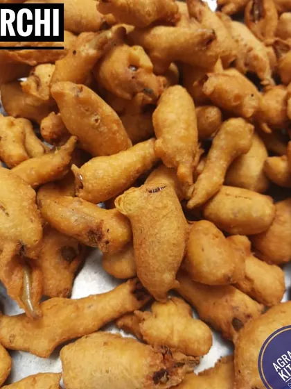 A tray full of hot Mirchi Bajji, a favorite snack for a rainy day. I use fresh green chillies, dip them in a seasoned gram flour batter, and fry them to golden perfection.