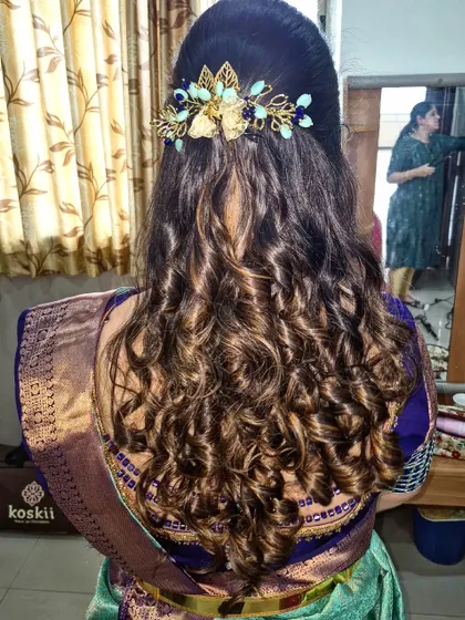 I love how these highlighted curls look with this unique gold and blue hair accessory. It adds a perfect pop of color and style.