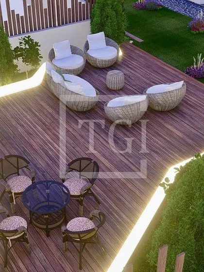 An overhead view of the wooden deck in the Noida project, highlighting the integrated lighting that outlines the different seating zones.