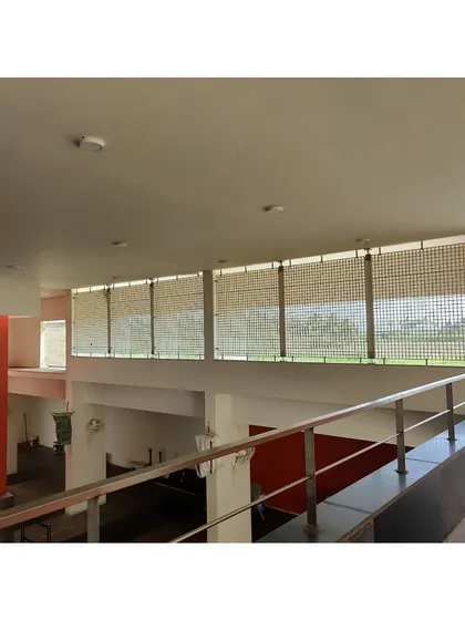 An interior view of the Sai Temple during construction, showing the use of bamboo screens to filter light and create a serene atmosphere.