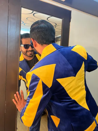 A look at the back of my blue and yellow jacket, designed with bold, star-like patterns that catch the light on stage.