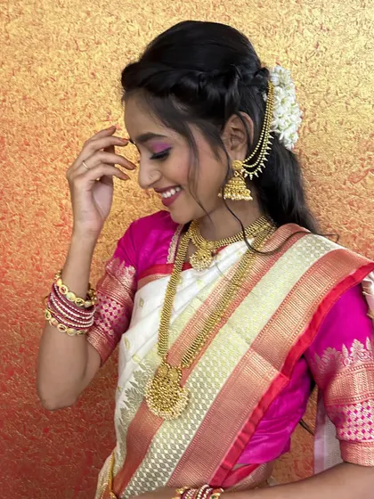 A happy and candid shot, showing the bride's joyful expression. The hairstyle is a simple yet elegant braid with fresh flowers.