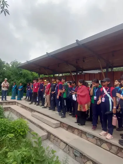 Students gather at the amphitheater in the Aravalli Biodiversity Park for an interactive session on native plants and conservation.