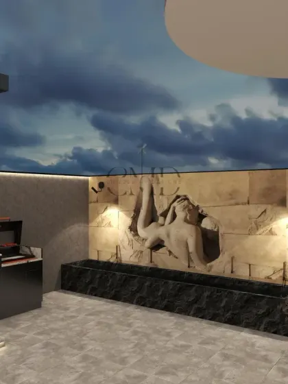 The terrace includes a calming wall fountain with a handcrafted stone carving, illuminated by soft cove lighting.
