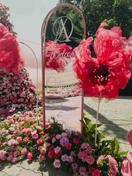 A shot of the beautiful and personalized decor at a Haldi carnival. The welcome sign and elaborate floral arrangements set the stage for a grand and joyful celebration.