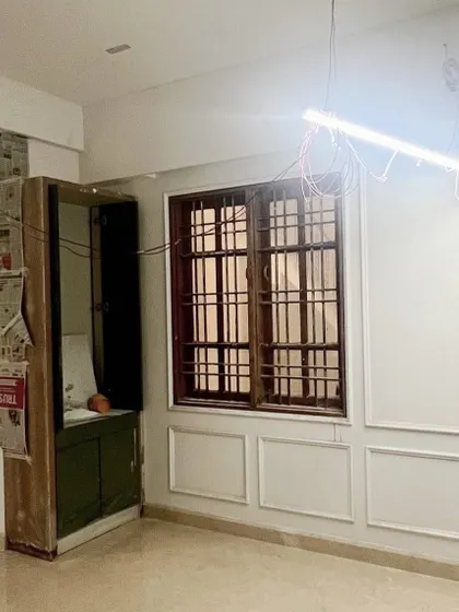 The dining room area during construction, with wall moldings being installed to set the foundation for its elegant transformation.