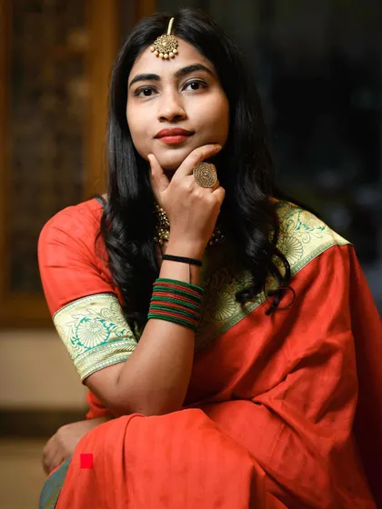 A beautiful portrait of a wedding guest from the 'ladkewale' or groom's side. Her elegant pose and traditional saree make for a stunning and timeless photograph.