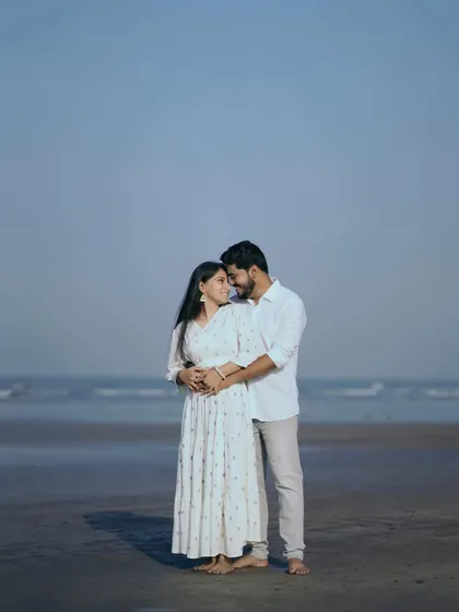 A wide shot of the couple on the beach, emphasizing the vastness of the sea and sky. It makes their connection feel both intimate and epic.
