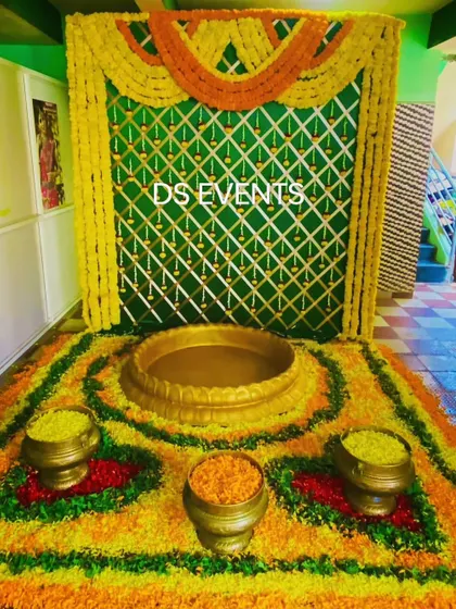 A beautiful floor arrangement for a Haldi ceremony. I created a floral rangoli using marigolds and other petals, with a central urli for the seating and smaller brass pots, all set against a traditional woven backdrop.