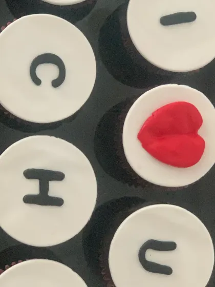 Cupcakes can carry a personal message. This set was designed for a special uncle ("Chachu"), spelling out a message of love with a heart accent, making for a unique and heartfelt gift.