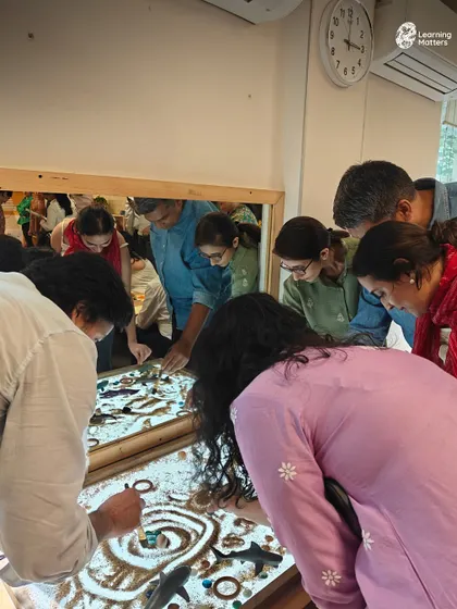 Parents get hands-on with the same sensory materials their children use. This shared exploration at the light table fosters empathy and gives parents a direct window into the power of play-based learning.