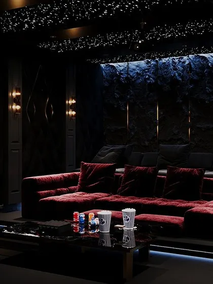 A close-up of the home theater, showing the KAWS figurine and the integrated LED lighting under the seating platform, which adds to the cool, modern vibe.
