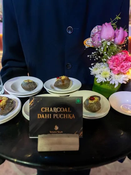 Our Charcoal Dahi Puchka, a modern and dramatic twist on a beloved Indian street food classic. The striking black colour and refined presentation make it a guaranteed conversation starter.