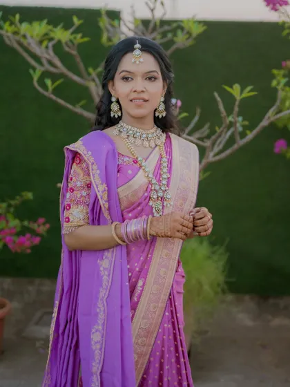 A confident and beautiful pose. The makeup is tailored to look perfect in outdoor lighting for her engagement photos.