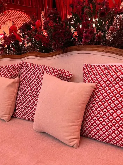 Simple yet elegant seating with custom-printed red and white cushions, perfectly matching the traditional theme.
