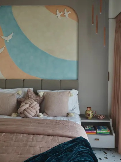 A close-up of the custom textured paint wall and soft bedding in this daughter's bedroom, creating a luxury sanctuary with a blend of soft hues and premium materials.