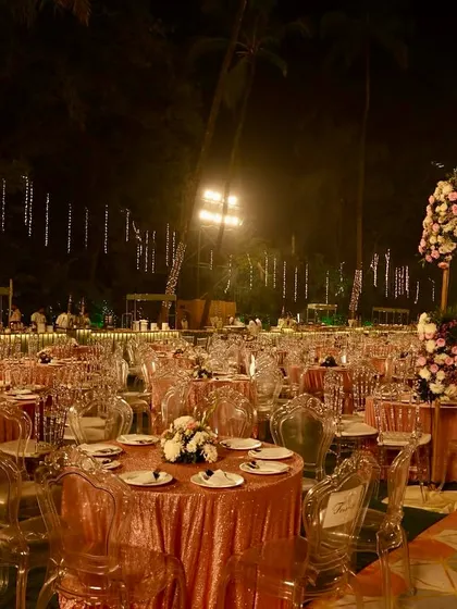 A wide view of a large reception seating area. We used a mix of table shapes and seating styles, including transparent ghost chairs, to add visual interest while maintaining a cohesive and elegant look.