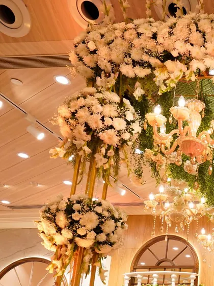 A breathtaking cluster of white carnations and a grand chandelier create a magical, dreamy atmosphere. This is designing at its best for your big day.