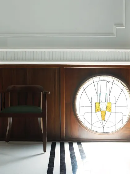 This is from a restaurant we renovated years ago, a heritage space where we restored the original Art Deco stained glass window. We added new flooring and wood paneling to complement the building's history, creating a space that feels both nostalgic and fresh.