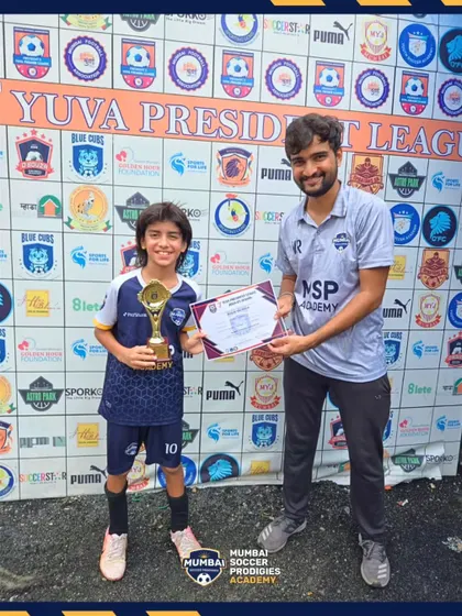 A player receives his award after a standout performance in the U11 Yuva President League.